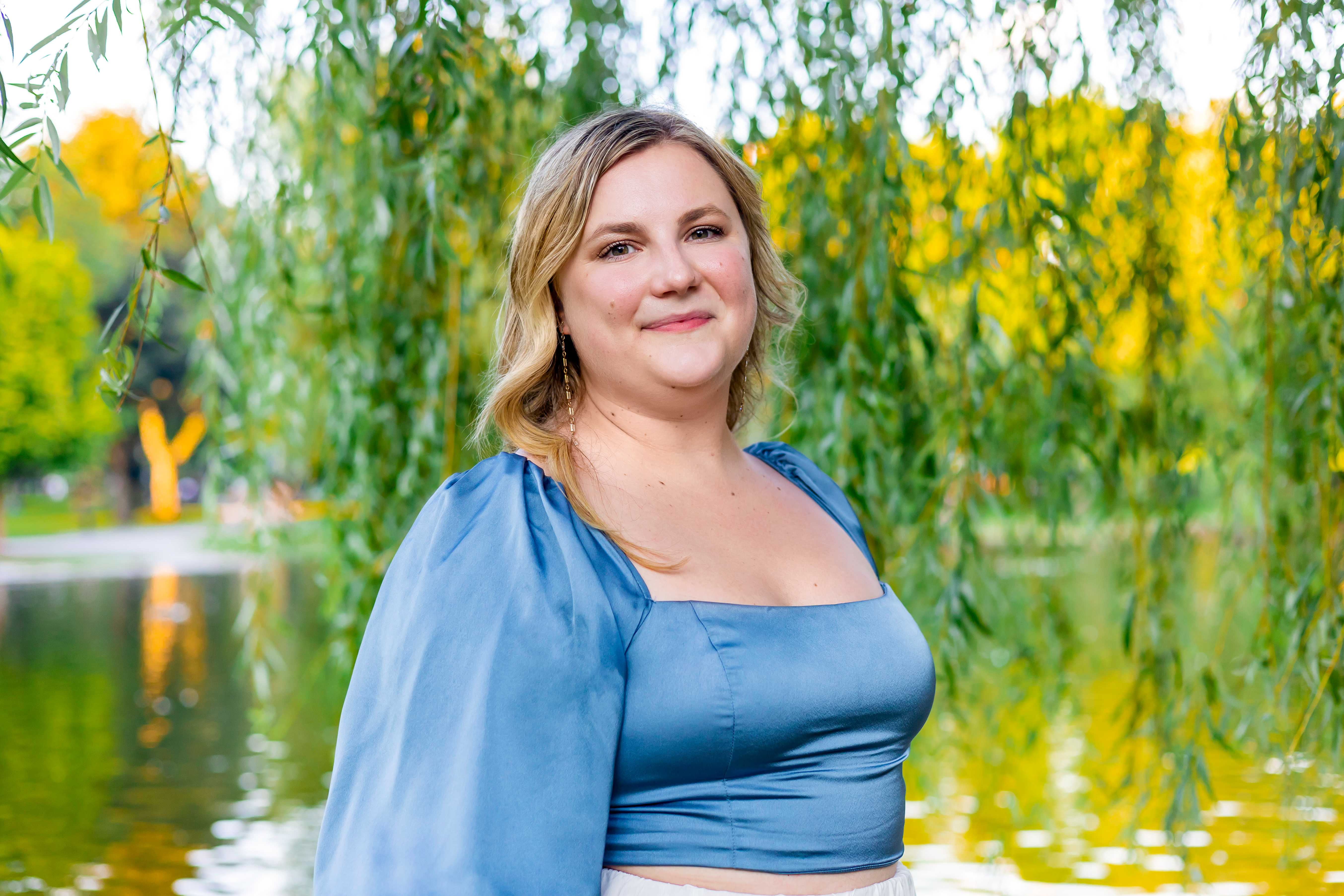 Larisa standing in front of a tree